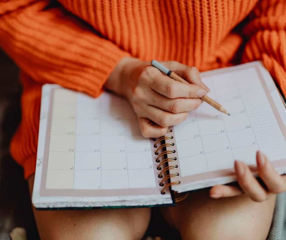 girl writing in a calendar